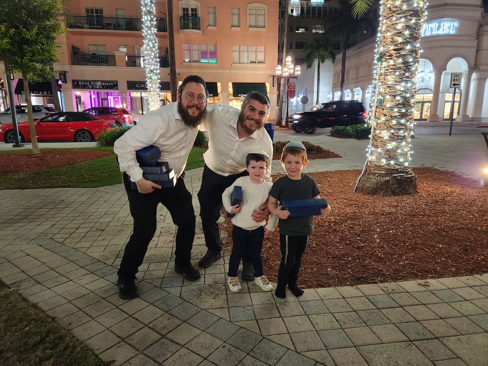 Team photo at a shopping area with menorahs