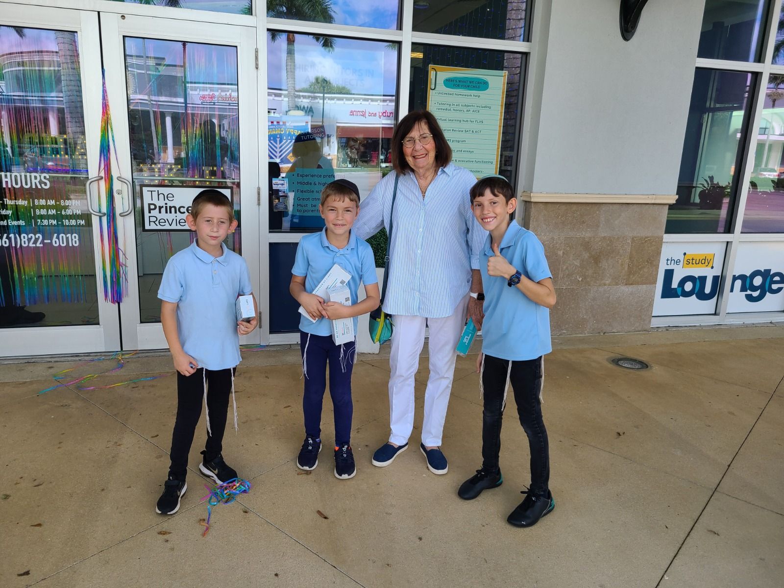 Volunteers distributing menorahs at a shopping center